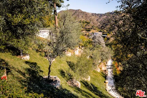 a balcony with large trees