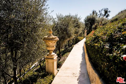 a view of a pathway covered with wooden fence