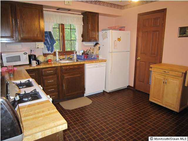 53 Nomoco Road Freehold, NJ 07728 - Photo 3 of 3 a kitchen with a refrigerator and a sink