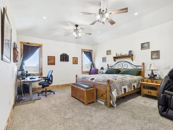 a bedroom with a bed and a chandelier