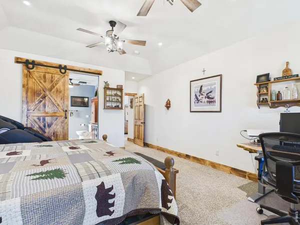 a bedroom that has a bed and a desk in it
