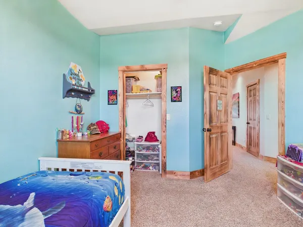 a bedroom with a bed and cabinets