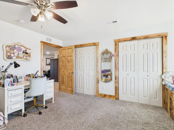 a view of a livingroom with furniture and a ceiling fan