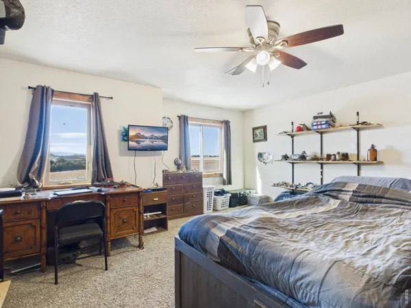 a bedroom with a large bed and a desk