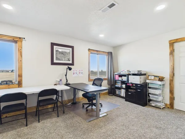 a living room with furniture and a dining table