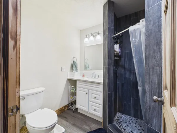 a bathroom with a toilet a sink a vanity and mirror