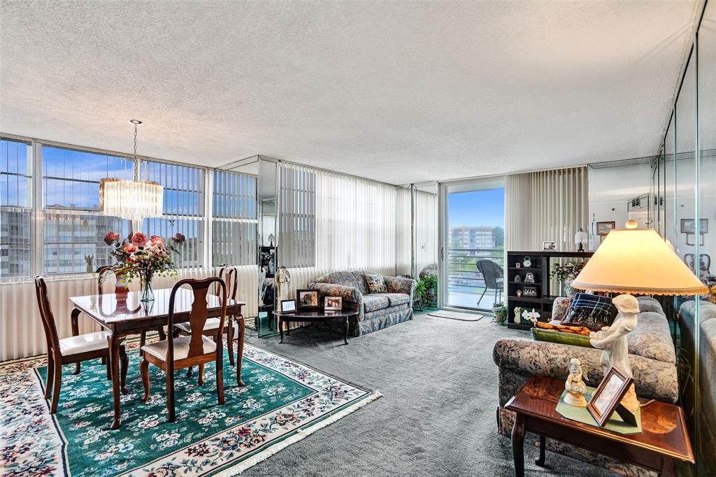 1100 St Charles Place, Unit 612 Pembroke Pines, FL 33026 - Photo 11 of 71 a living room with furniture and a table