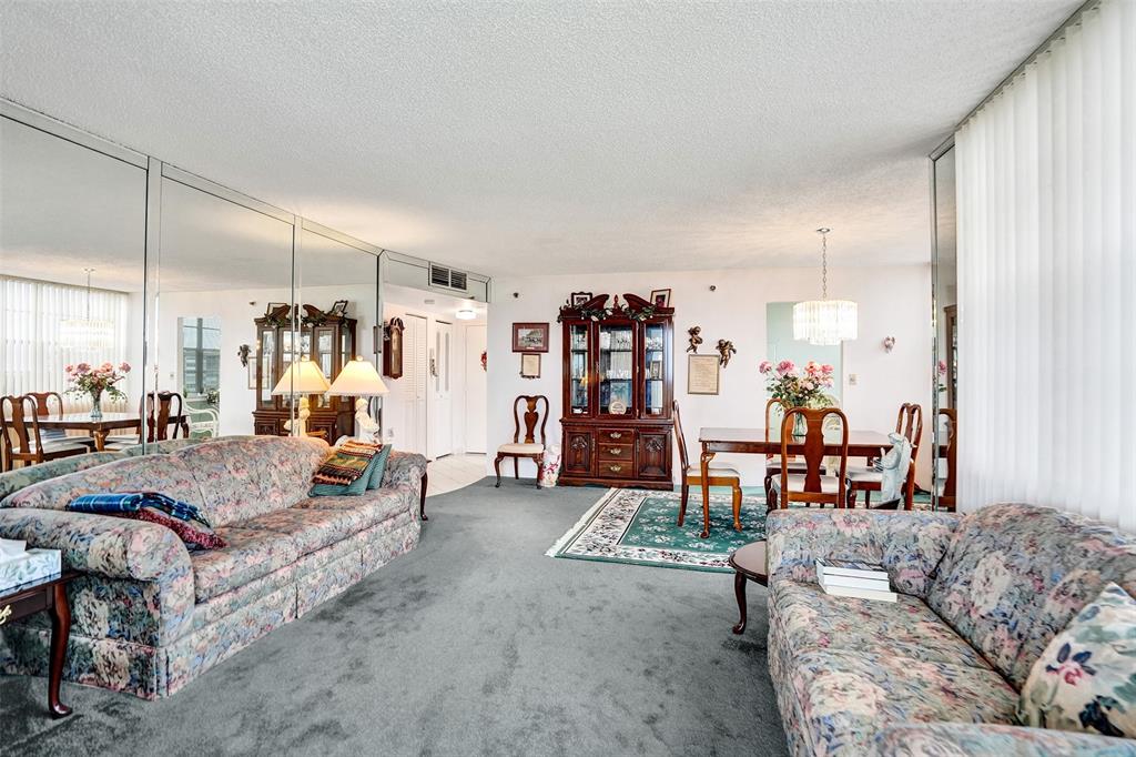 1100 St Charles Place, Unit 612 Pembroke Pines, FL 33026 - Photo 13 of 71 a living room with furniture and wooden floor