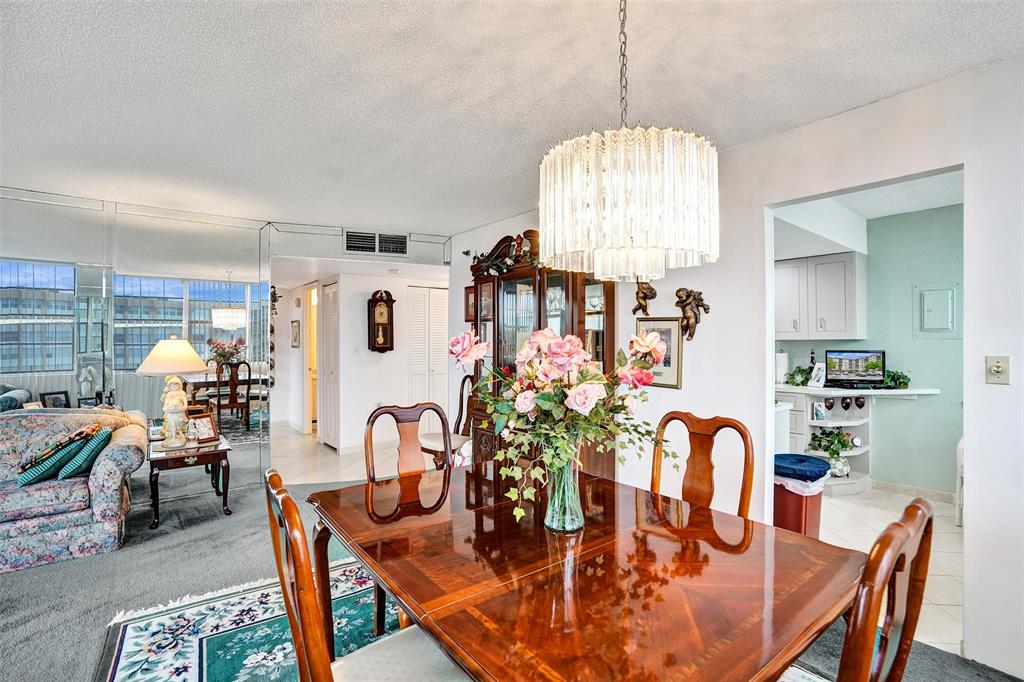 1100 St Charles Place, Unit 612 Pembroke Pines, FL 33026 - Photo 14 of 71 a view of a dining room with furniture and chandelier