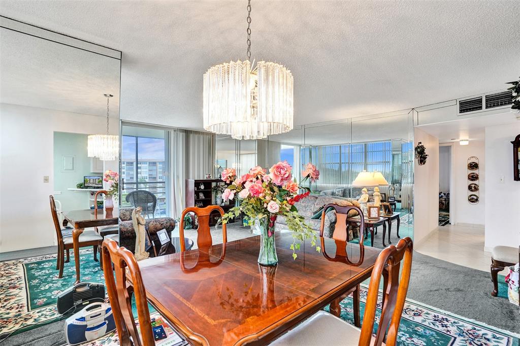 1100 St Charles Place, Unit 612 Pembroke Pines, FL 33026 - Photo 15 of 71 a dining room filled chandelier and kitchen view