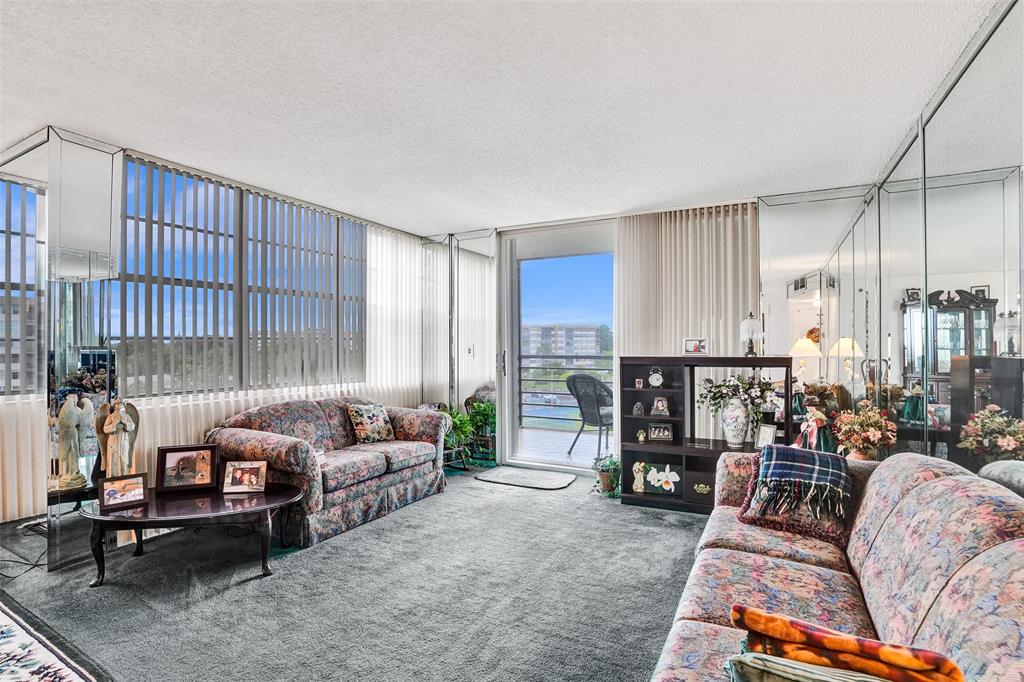 1100 St Charles Place, Unit 612 Pembroke Pines, FL 33026 - Photo 18 of 71 a living room with furniture and a large window