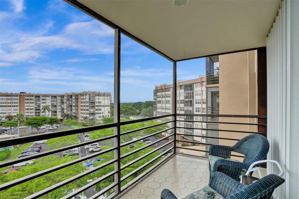 1100 St Charles Place, Unit 612 Pembroke Pines, FL 33026 - Photo 21 of 71 a view of a balcony with floor to ceiling windows with wooden floor