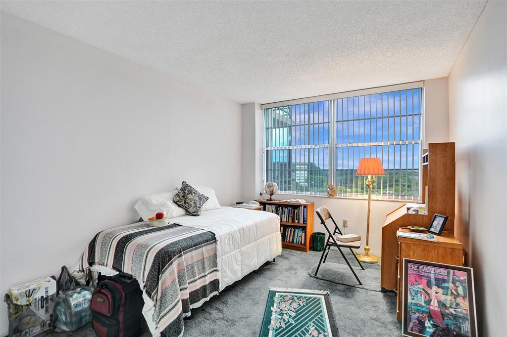 1100 St Charles Place, Unit 612 Pembroke Pines, FL 33026 - Photo 25 of 71 a bedroom with a bed and a flat screen tv