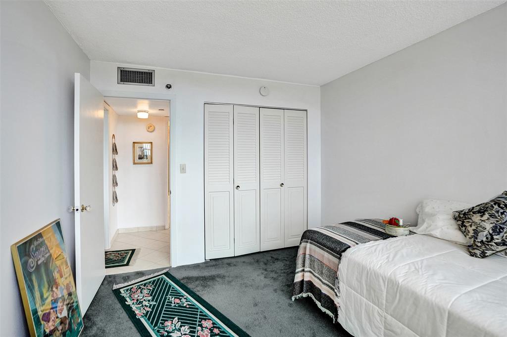 1100 St Charles Place, Unit 612 Pembroke Pines, FL 33026 - Photo 28 of 71 a bedroom with a bed and a couch