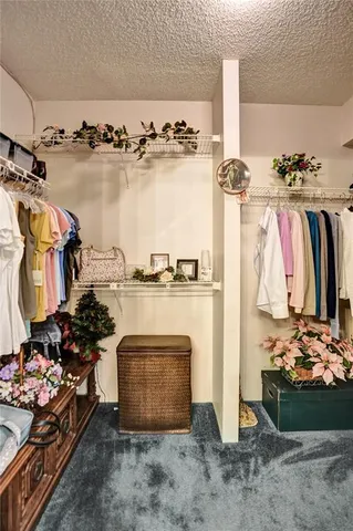 a view of a patio with a table and chairs under an umbrella
