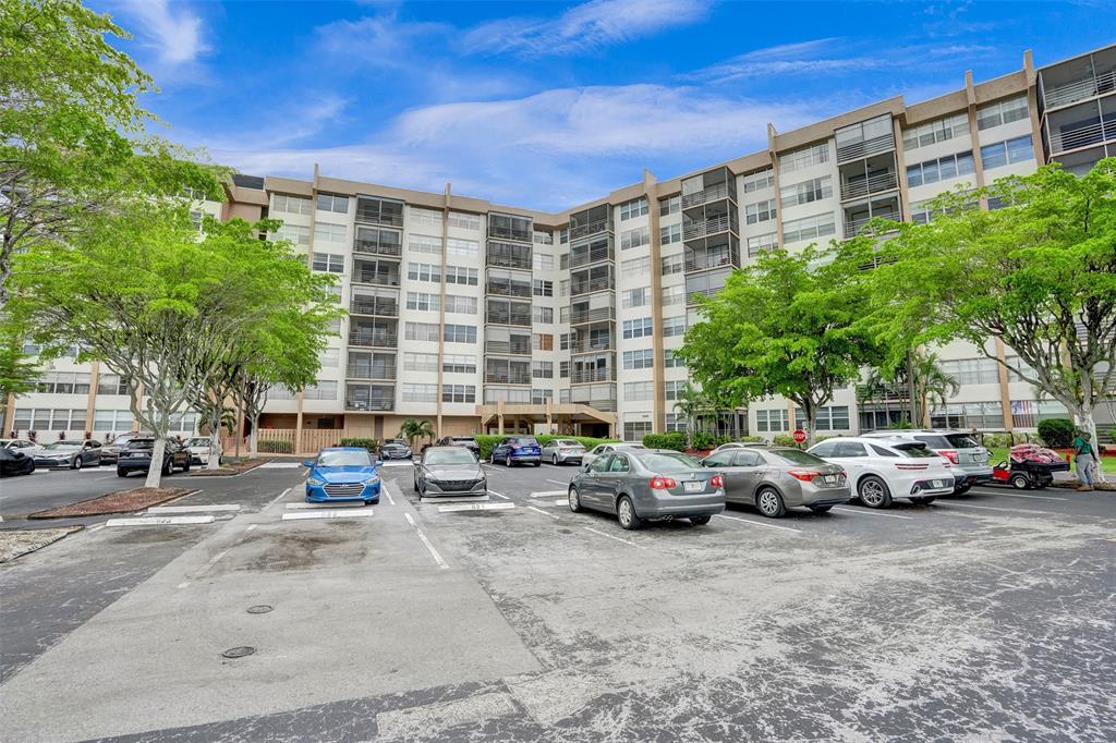 1100 St Charles Place, Unit 612 Pembroke Pines, FL 33026 - Photo 49 of 71 a cars parked in front of a building