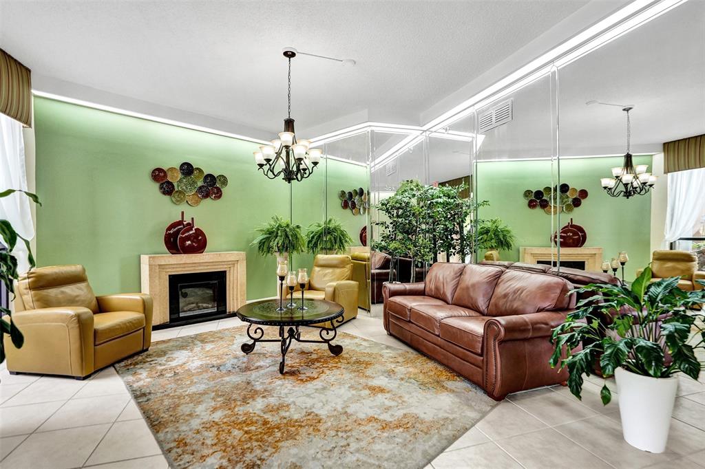 1100 St Charles Place, Unit 612 Pembroke Pines, FL 33026 - Photo 54 of 71 a living room with furniture and a fireplace