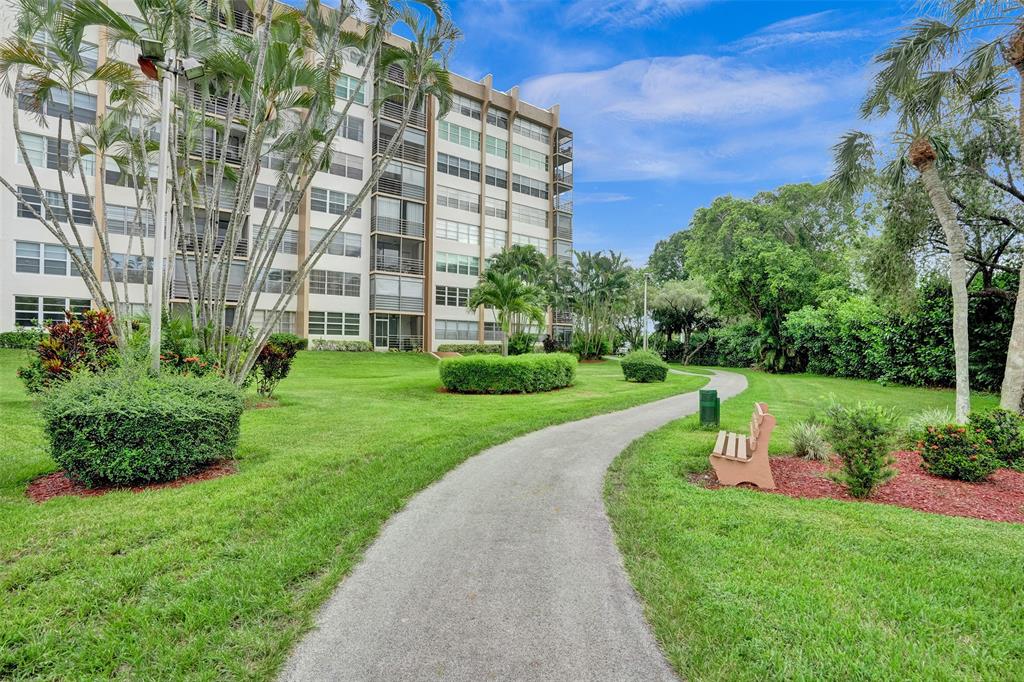 1100 St Charles Place, Unit 612 Pembroke Pines, FL 33026 - Photo 69 of 71 a view of a building with garden
