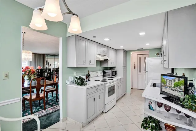 a view of a dining room with furniture and chandelier