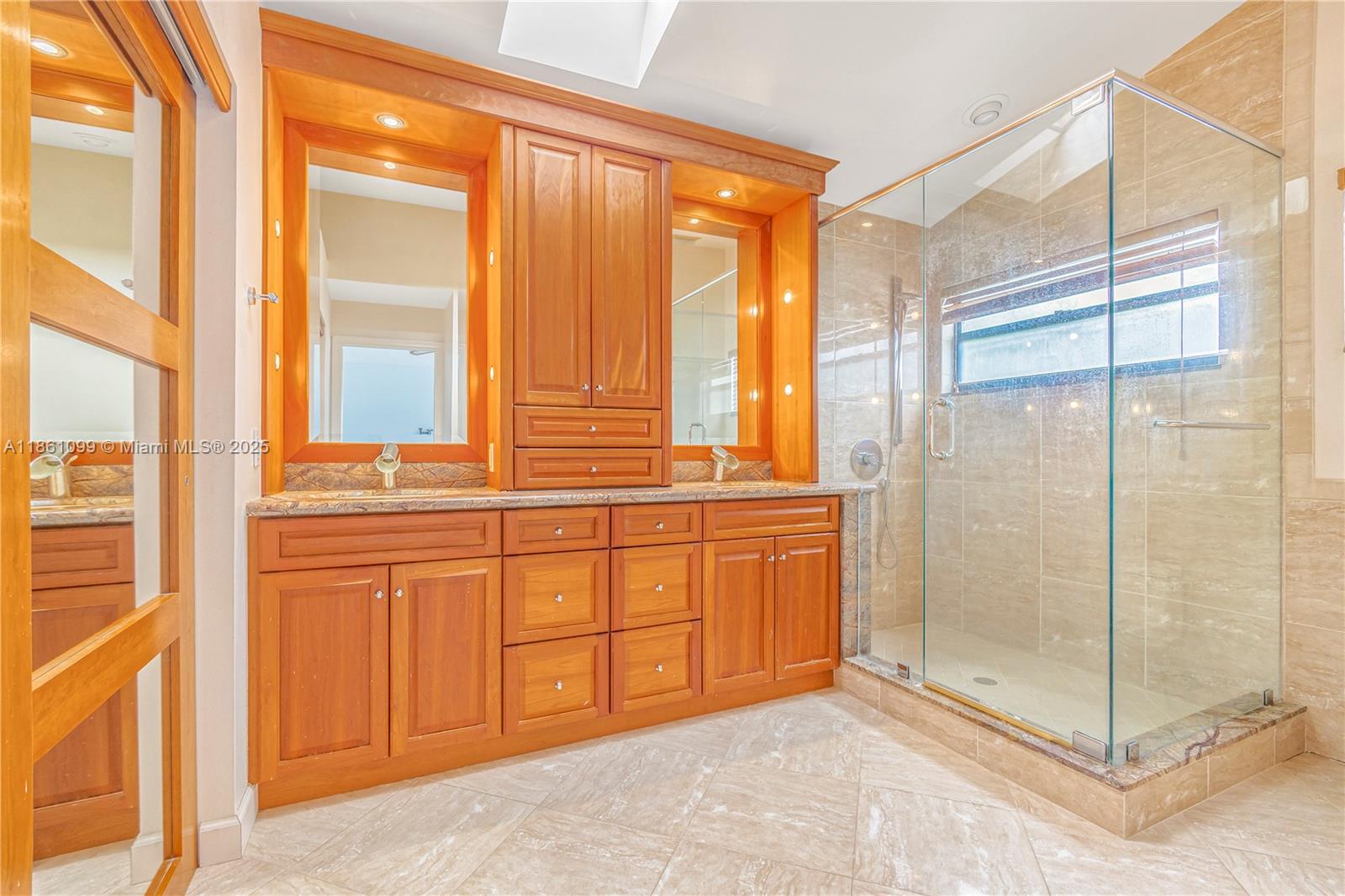 5535 Eton Court Boca Raton, FL 33486 - Photo 33 of 61 a view of a bathroom with a glass shower door