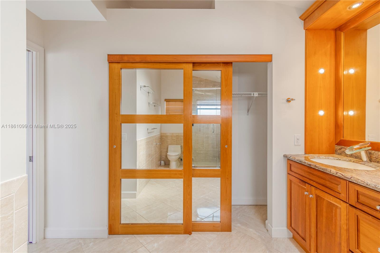5535 Eton Court Boca Raton, FL 33486 - Photo 36 of 61 a view of a bathroom with a sink