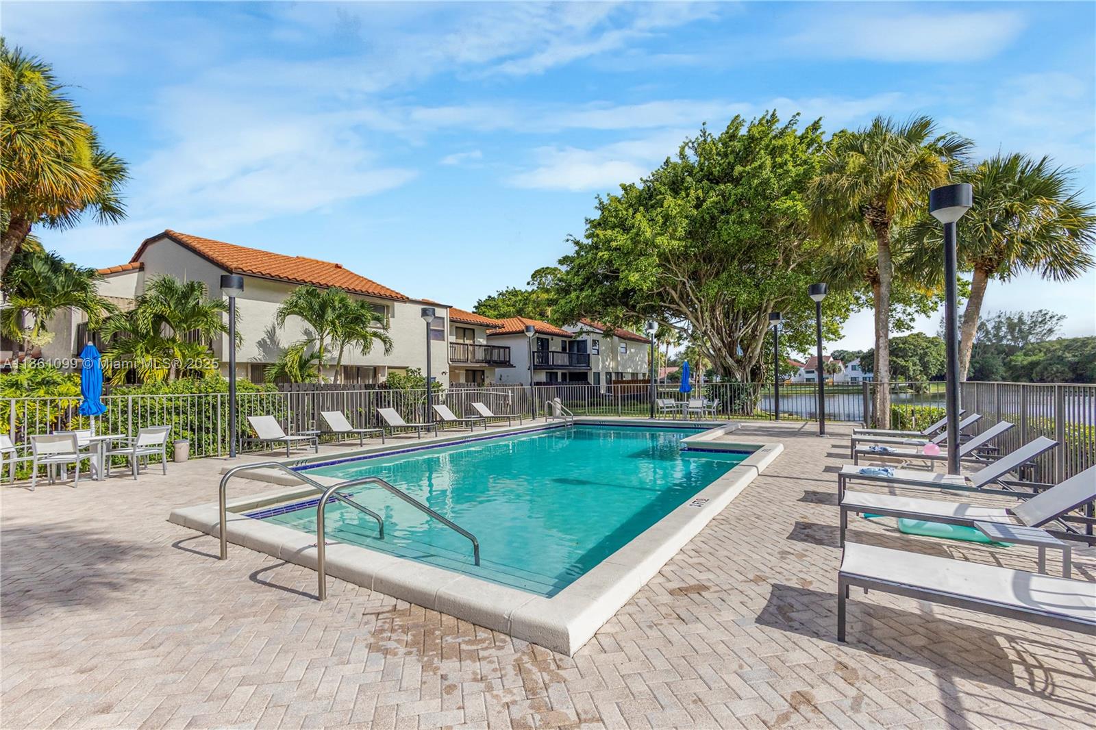 5535 Eton Court Boca Raton, FL 33486 - Photo 47 of 61 a view of a swimming pool with a patio