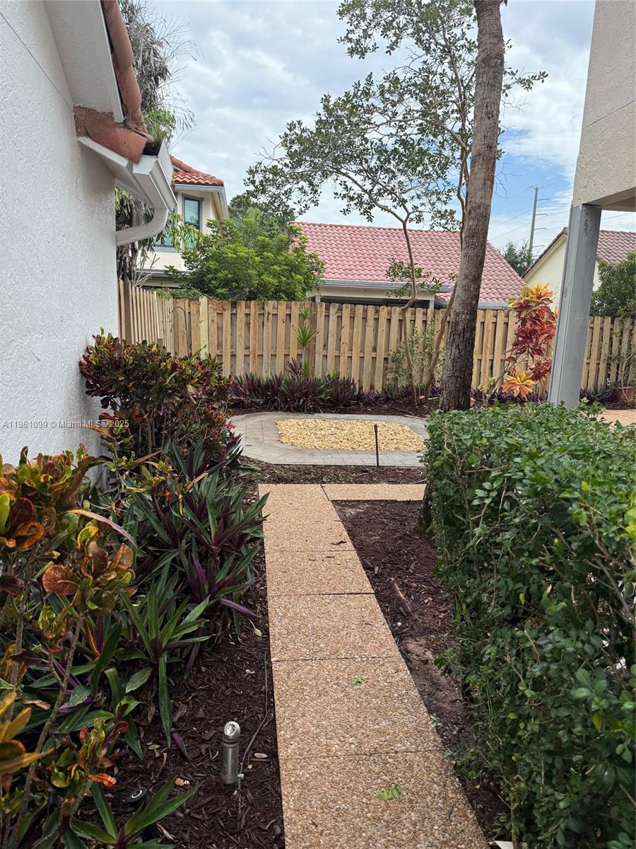 5535 Eton Court Boca Raton, FL 33486 - Photo 50 of 61 a view of a pathway with a garden