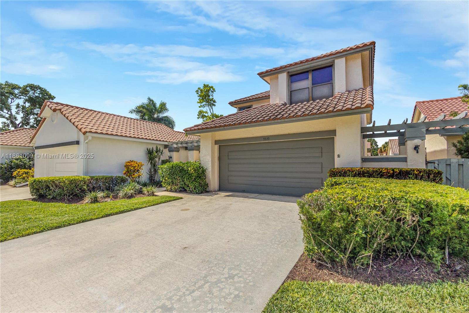 5535 Eton Court Boca Raton, FL 33486 - Photo 5 of 61 a front view of a house with a yard and garage