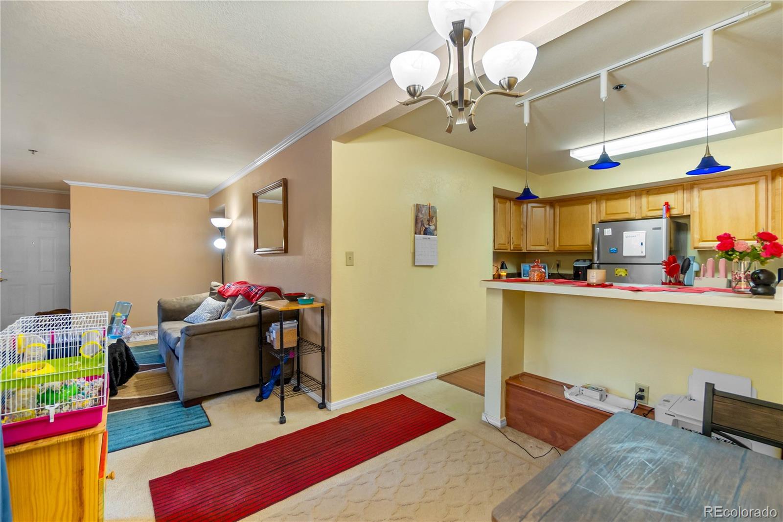 2170 Alicia Point, Unit 102 Colorado Springs, CO 80919 - Photo 12 of 37 a living room with furniture and a wooden floor