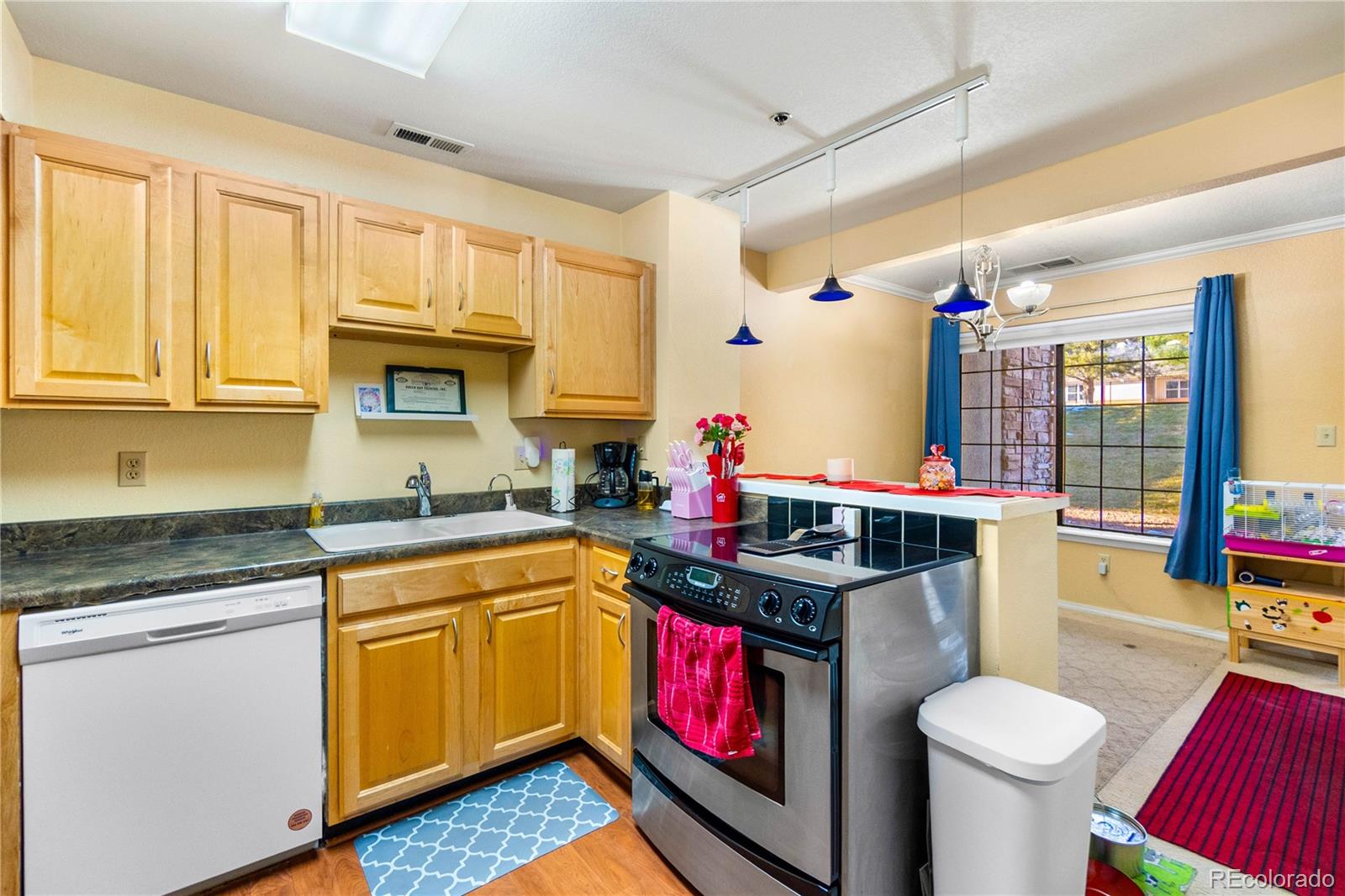 2170 Alicia Point, Unit 102 Colorado Springs, CO 80919 - Photo 15 of 37 a kitchen with stainless steel appliances granite countertop a sink stove and cabinets