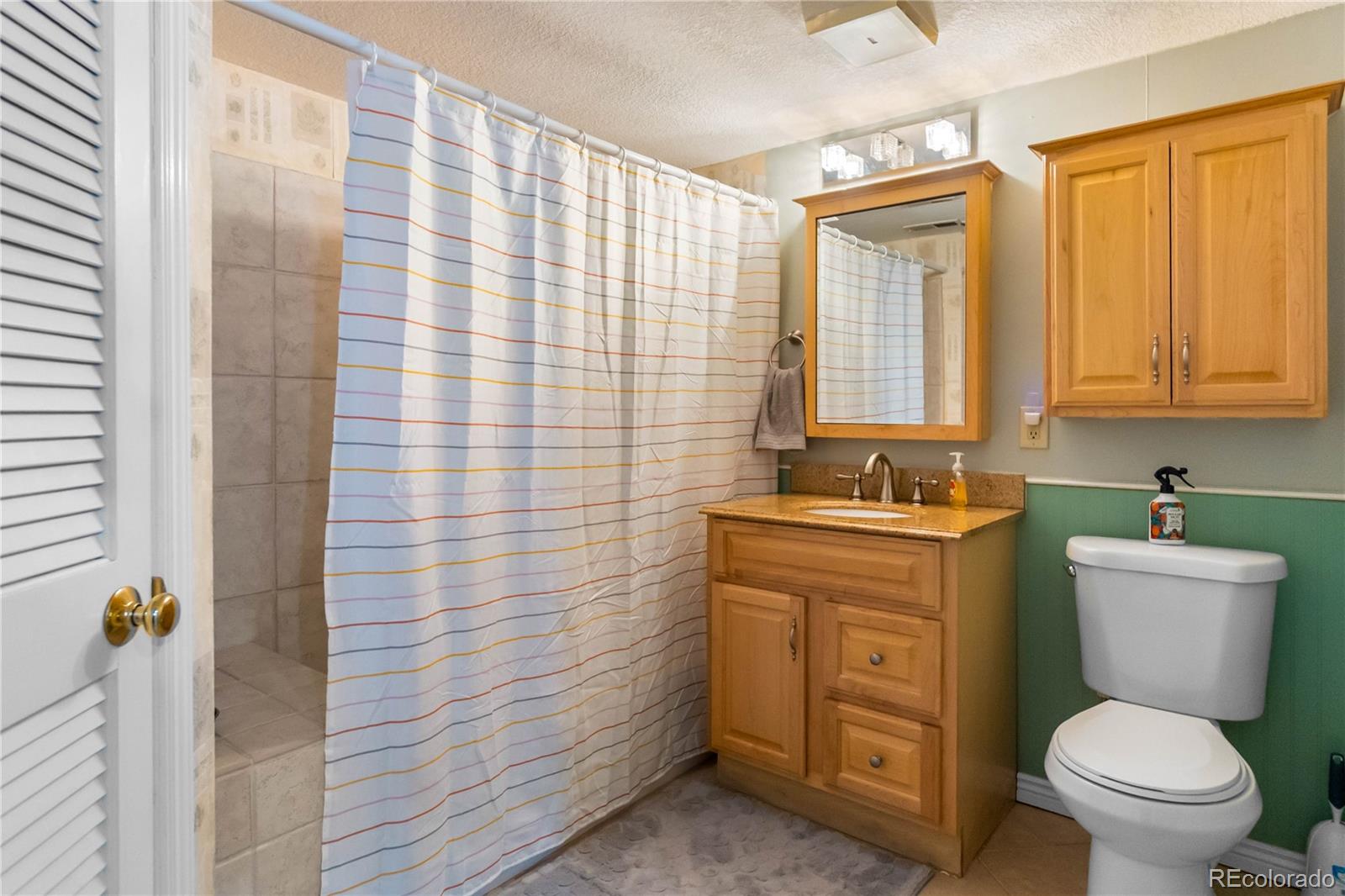 2170 Alicia Point, Unit 102 Colorado Springs, CO 80919 - Photo 23 of 37 a bathroom with a sink a toilet and shower