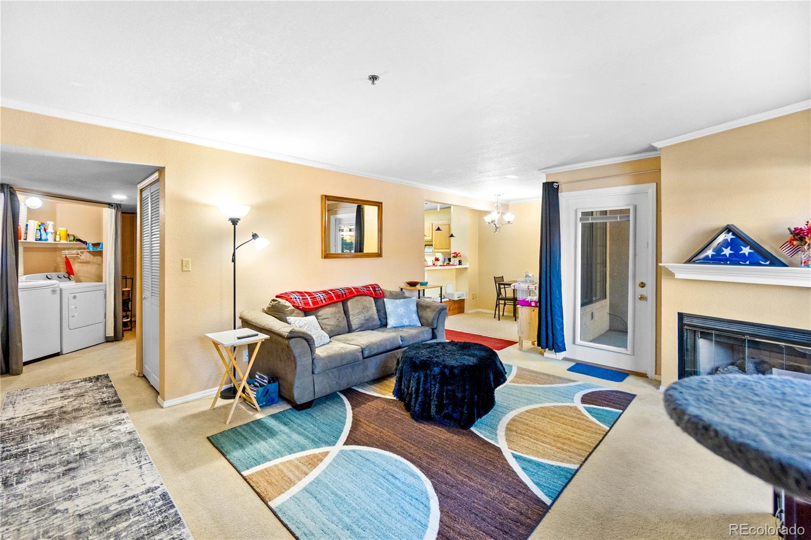 2170 Alicia Point, Unit 102 Colorado Springs, CO 80919 - Photo 8 of 37 a living room with furniture and a fireplace