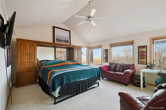 a bedroom with a bed couch and window