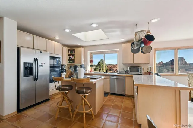 a kitchen with refrigerator and cabinets