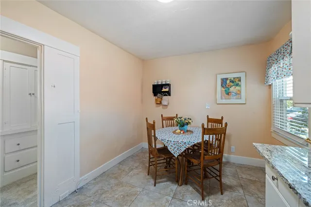 a kitchen with granite countertop a stove sink and microwave