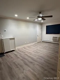 a view of an empty room with a ceiling fan window and a ceiling fan
