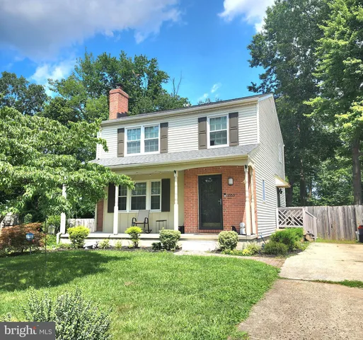 a front view of a house with a yard and porch