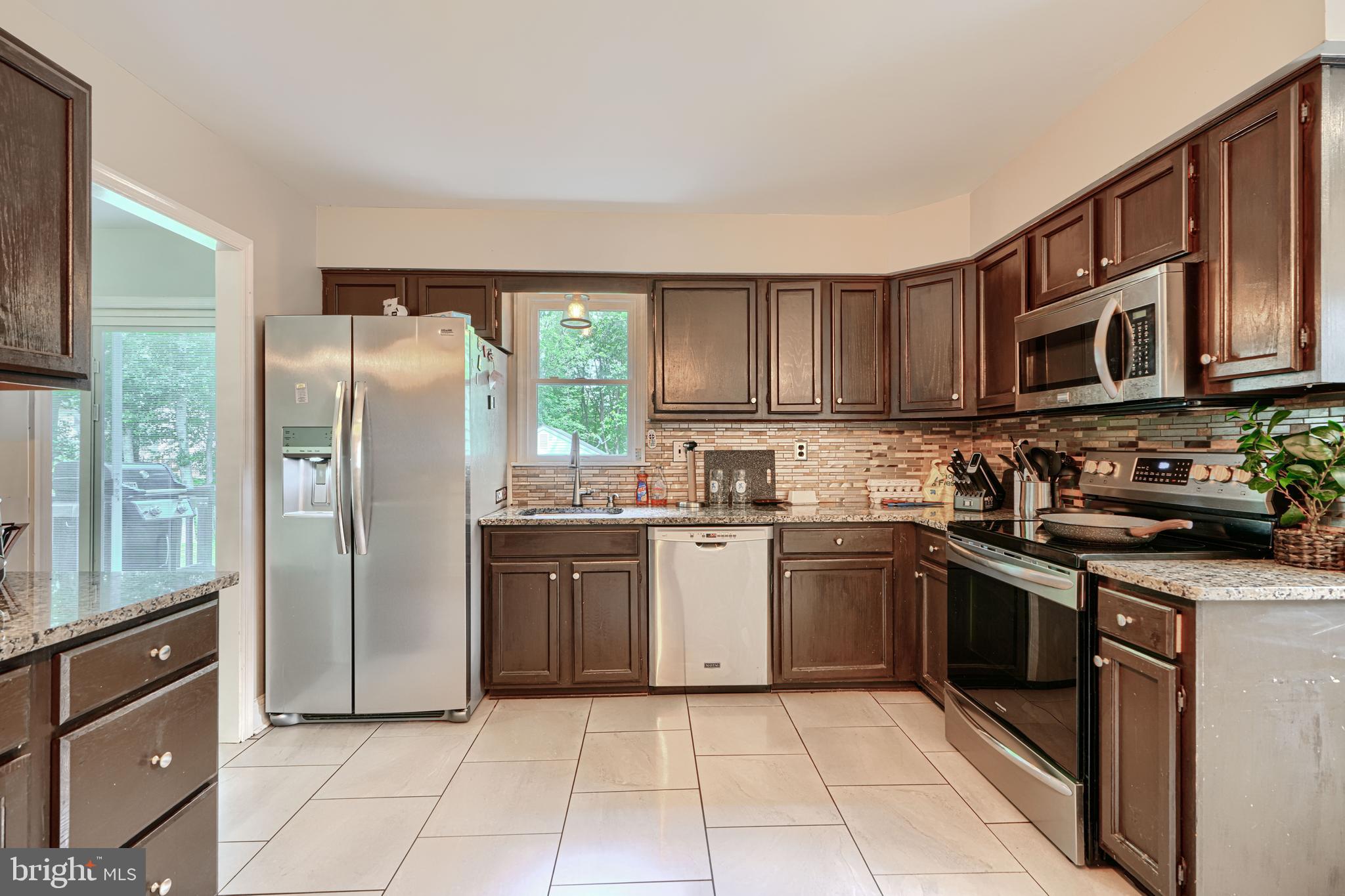 1353 Sweetbriar Lane Bel Air, MD 21014 - Photo 13 of 43 a kitchen with stainless steel appliances granite countertop a refrigerator stove a sink and a microwave