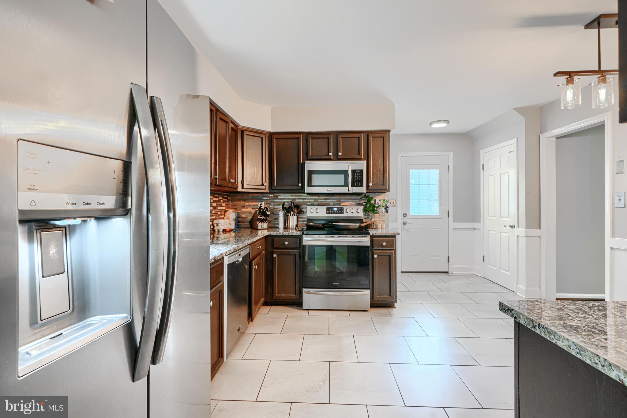 1353 Sweetbriar Lane Bel Air, MD 21014 - Photo 15 of 43 a kitchen with stainless steel appliances granite countertop a refrigerator and a stove top oven