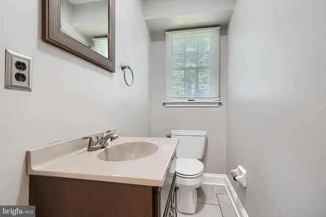 a white toilet sitting next to a bathroom sink