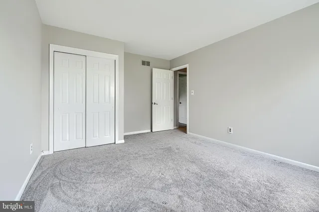 a view of an empty room and closet area