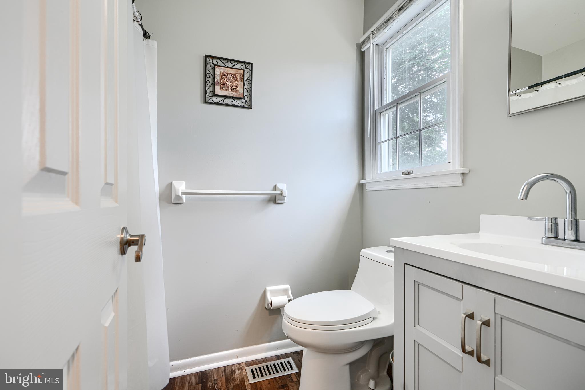 1353 Sweetbriar Lane Bel Air, MD 21014 - Photo 21 of 43 a bathroom with a sink mirror vanity and toilet