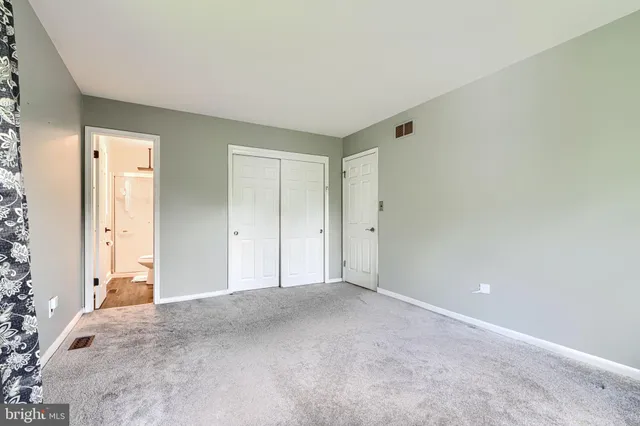 a view of an empty room and closet area