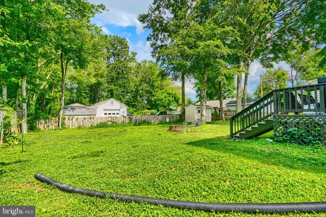 a house with a big yard and large trees