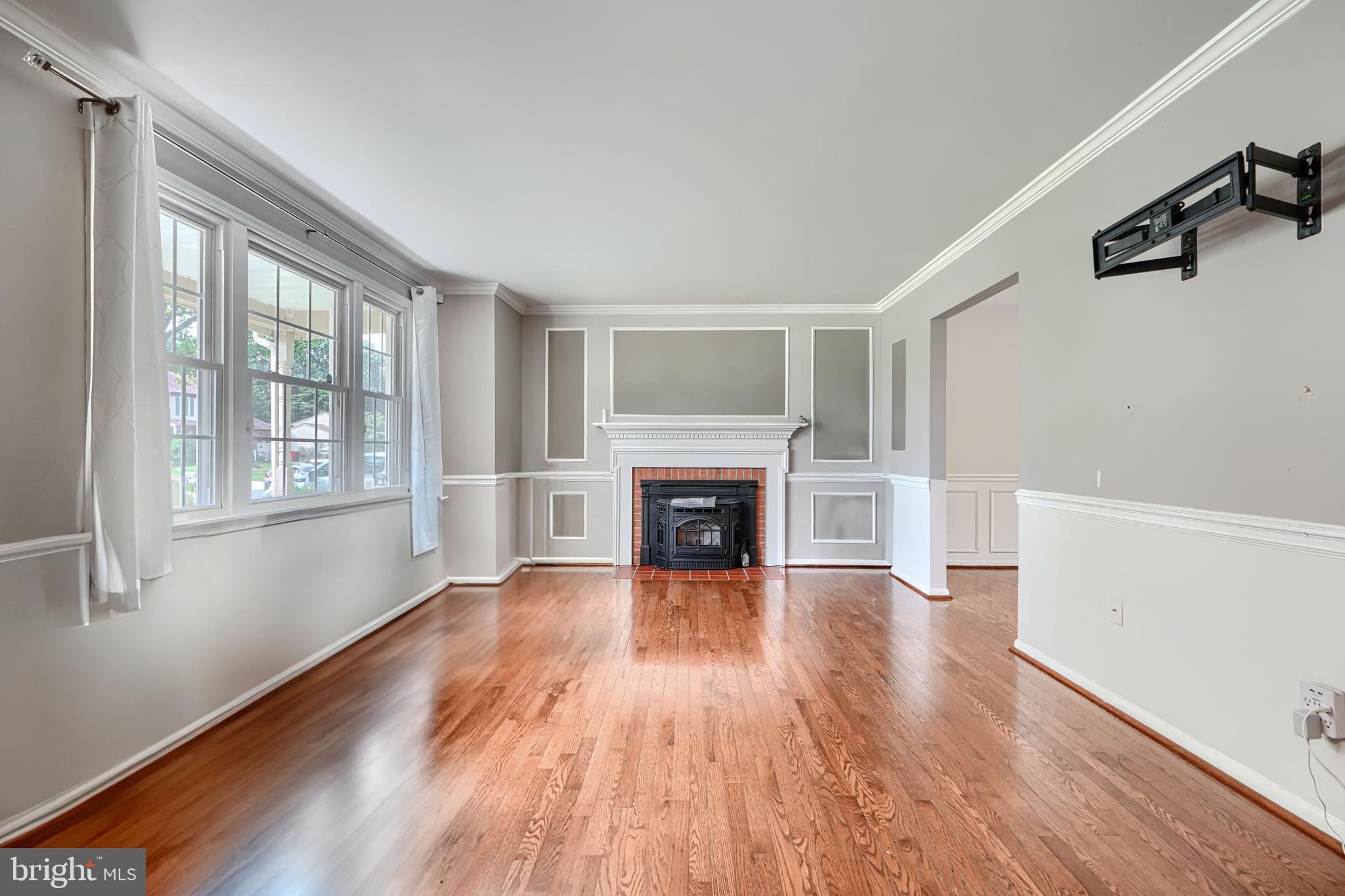 1353 Sweetbriar Lane Bel Air, MD 21014 - Photo 7 of 43 a view of an empty room with wooden floor fireplace and a window