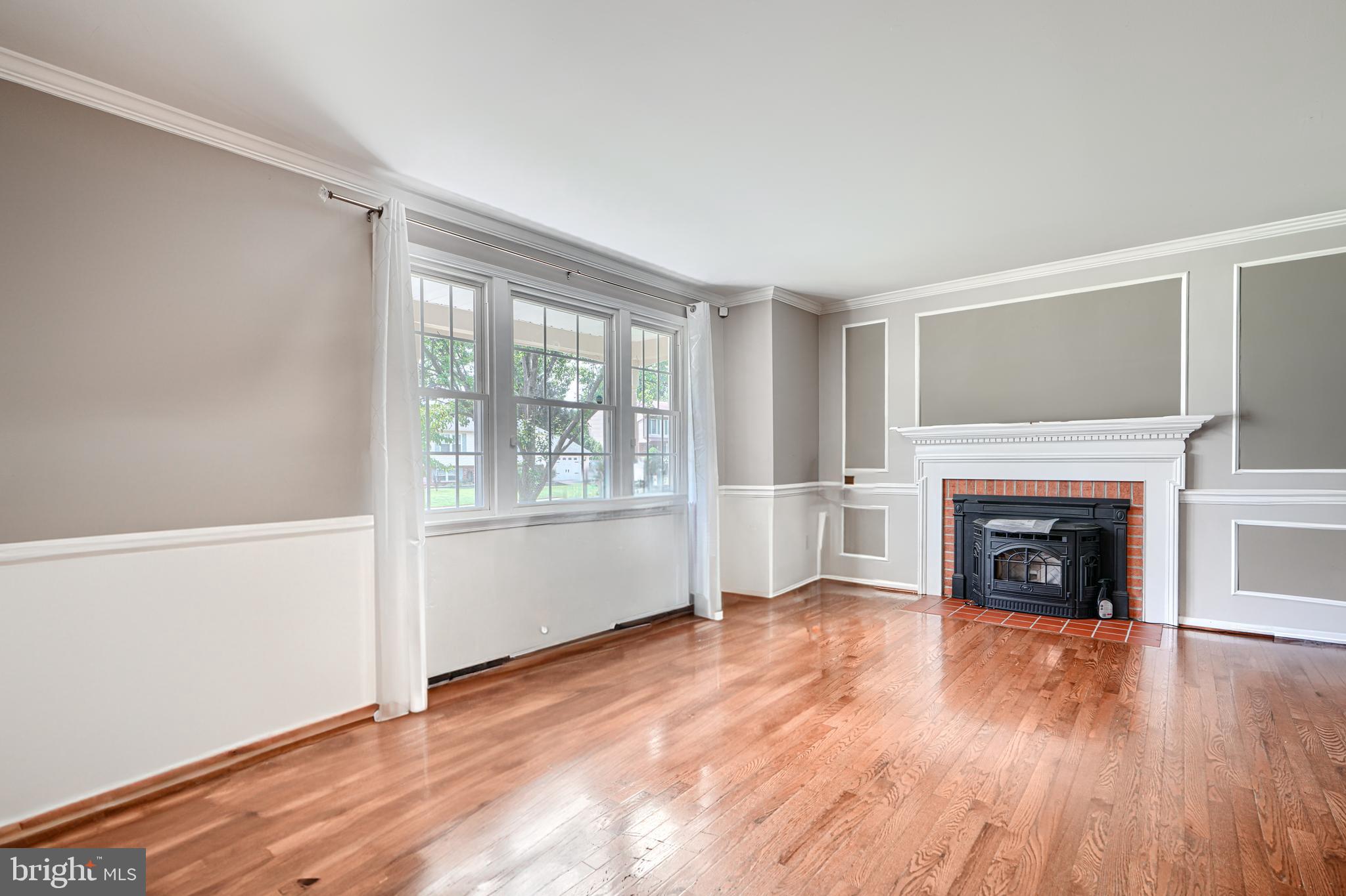 1353 Sweetbriar Lane Bel Air, MD 21014 - Photo 8 of 43 an empty room with wooden floor fireplace and windows