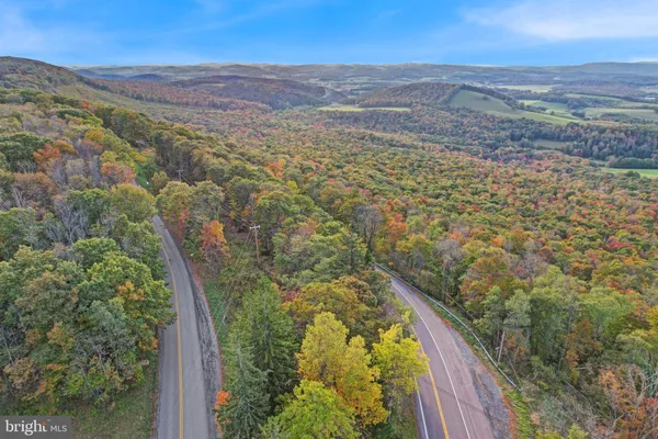 a view of a large mountain with mountains in the background