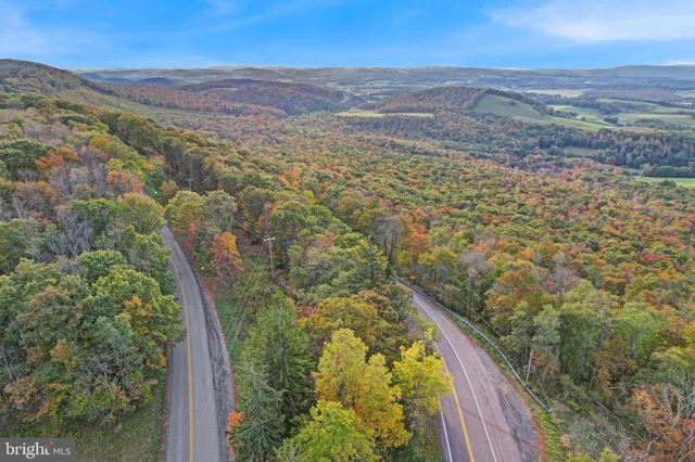a view of a large mountain with mountains in the background