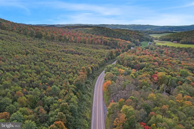 a view of a large mountain with mountains in the background