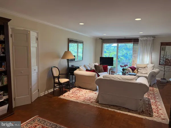 a living room with furniture a window and a lamp